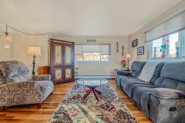 living room with baseboard heating and hardwood / wood-style floors