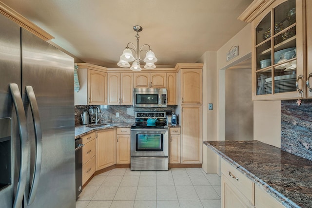 kitchen with appliances with stainless steel finishes, decorative backsplash, light brown cabinets, and hanging light fixtures