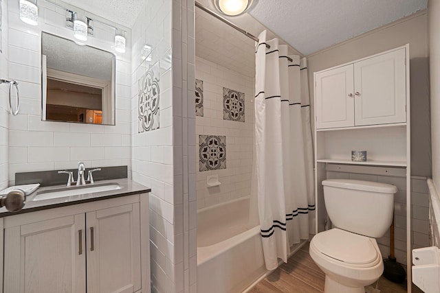 full bathroom with toilet, wood-type flooring, shower / bath combination with curtain, and a textured ceiling