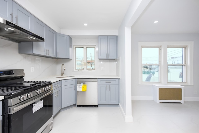 kitchen featuring gray cabinets, backsplash, gas range, dishwasher, and sink