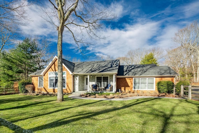 back of house featuring covered porch and a lawn