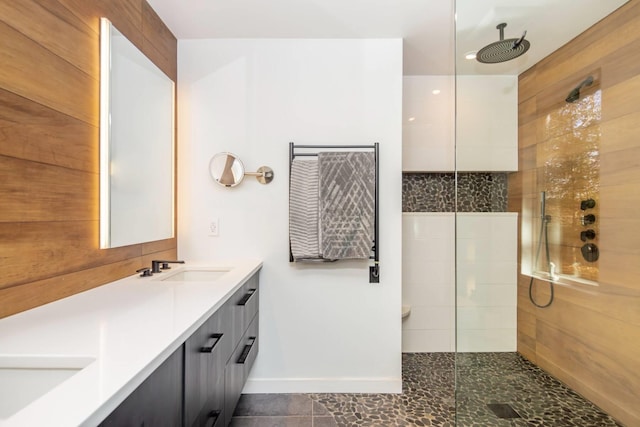 bathroom featuring tiled shower and vanity