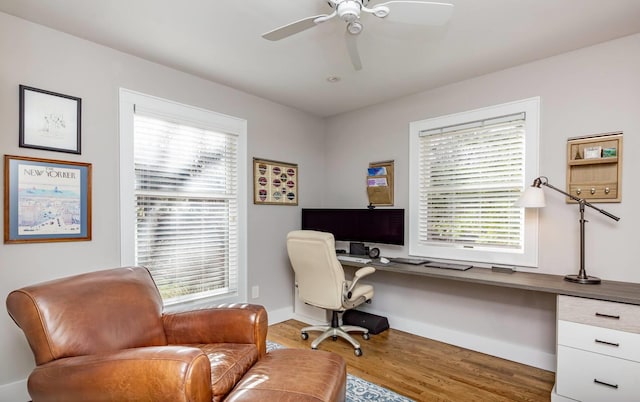 office area with hardwood / wood-style flooring, ceiling fan, and built in desk