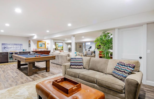 rec room with pool table, light wood-type flooring, and indoor bar