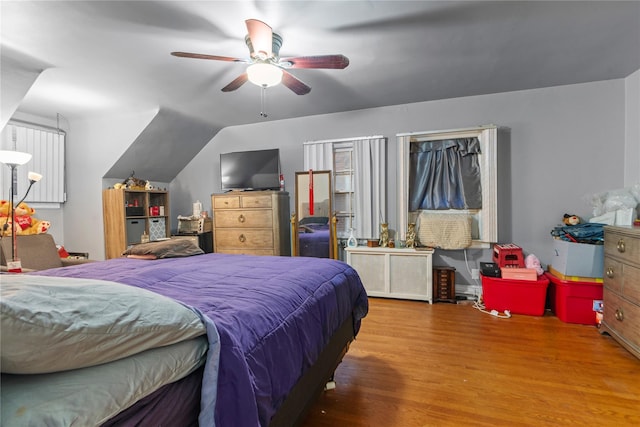 bedroom featuring hardwood / wood-style flooring, vaulted ceiling, and ceiling fan