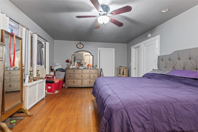 bedroom featuring light wood-type flooring and ceiling fan