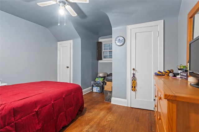 bedroom featuring wood-type flooring, vaulted ceiling, and ceiling fan