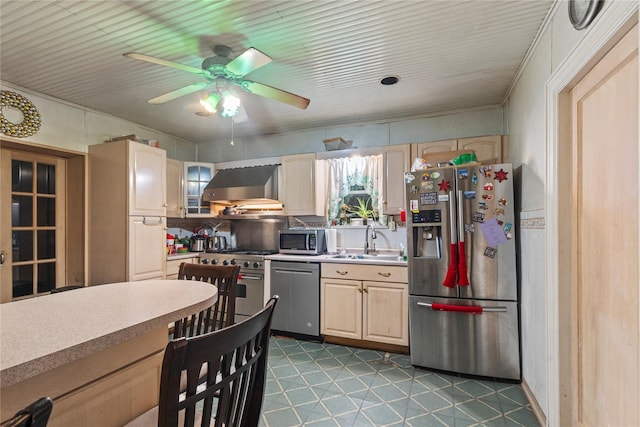 kitchen featuring light brown cabinetry, stainless steel appliances, wall chimney exhaust hood, and sink