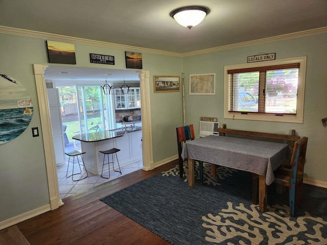 dining space featuring hardwood / wood-style floors, a wall mounted air conditioner, and ornamental molding