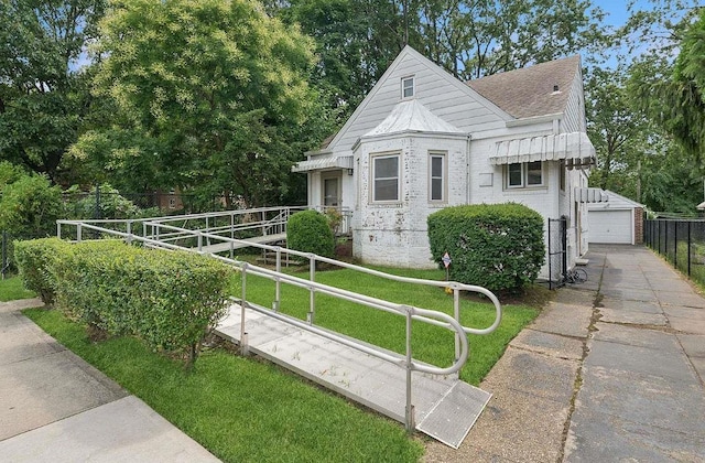 view of front of home with an outbuilding, a garage, and a front yard