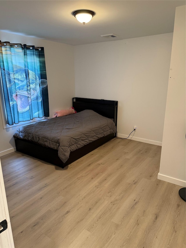 bedroom with light wood-type flooring