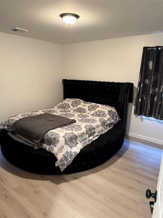 bedroom with light wood-type flooring