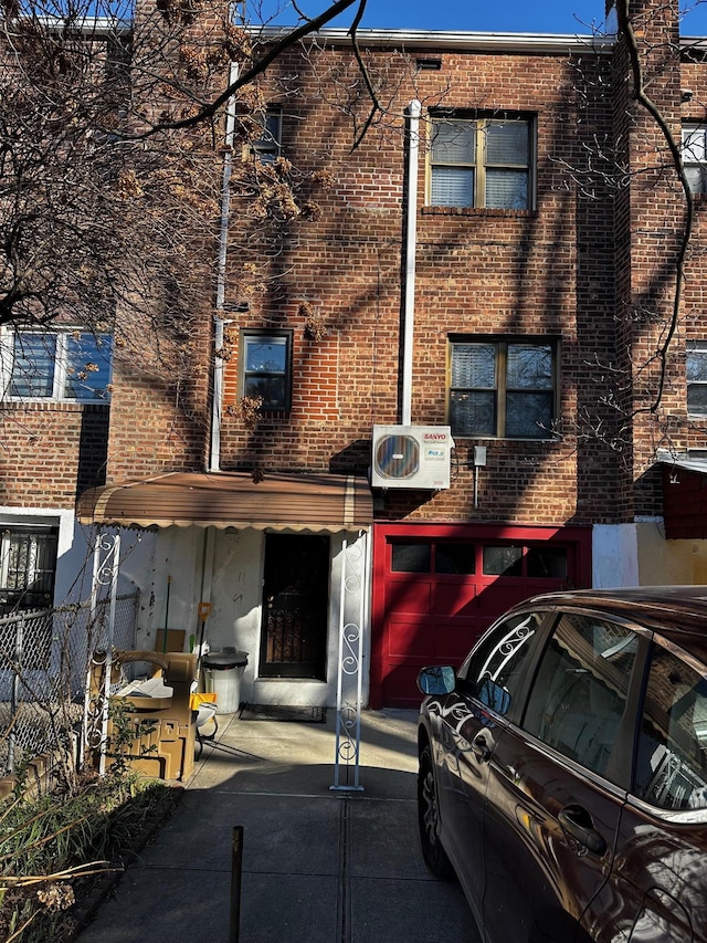 view of front of house with ac unit and a garage