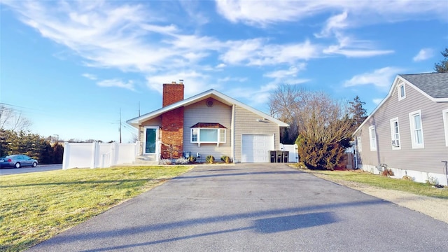 view of front of property featuring a garage and a front yard