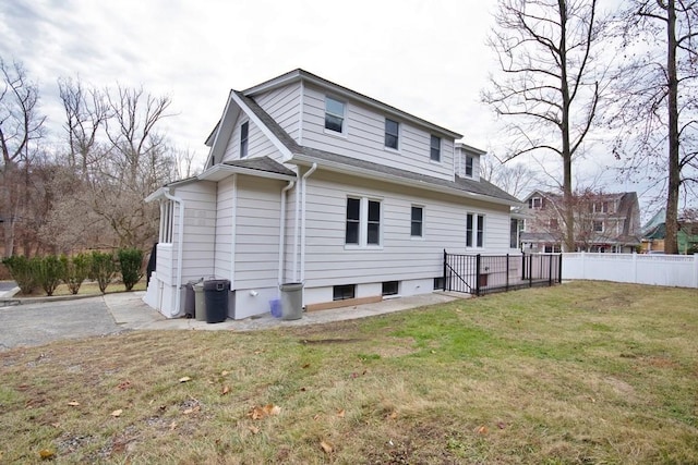 rear view of house featuring a lawn