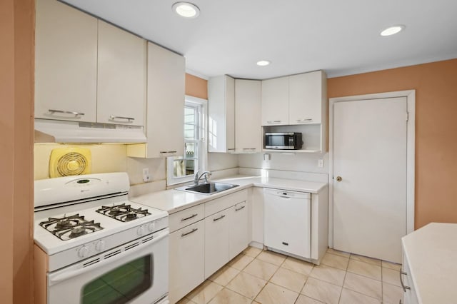 kitchen featuring light tile patterned floors, sink, white appliances, and white cabinets