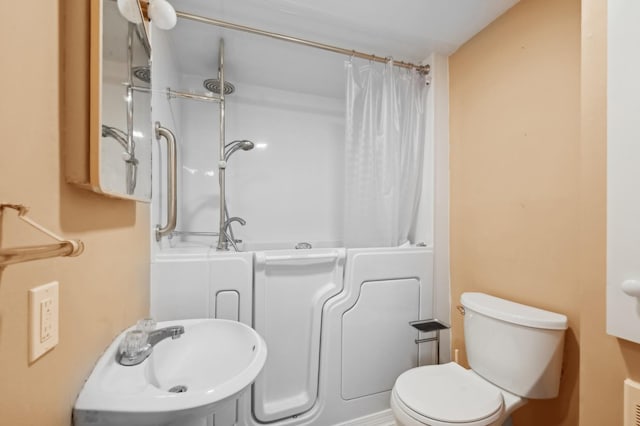 full bathroom with toilet, shower / bathtub combination with curtain, and sink