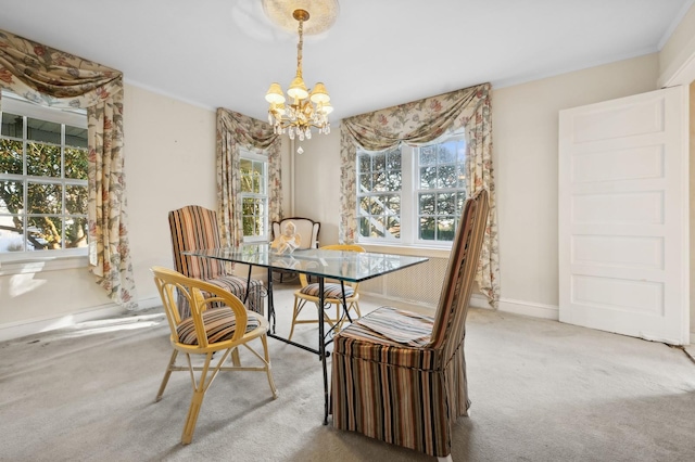 dining room featuring an inviting chandelier and carpet flooring