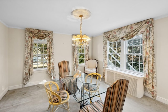 dining space with light carpet, an inviting chandelier, a healthy amount of sunlight, and radiator heating unit