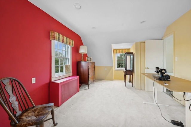 living area with carpet floors, radiator heating unit, and vaulted ceiling