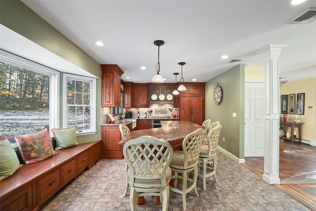 dining room with decorative columns