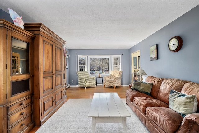 living room featuring a textured ceiling and light hardwood / wood-style floors