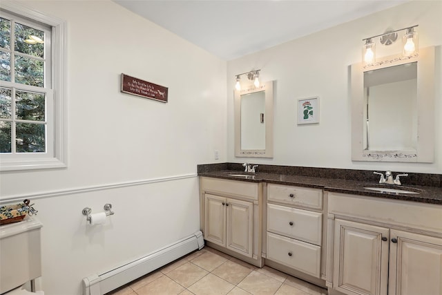 bathroom featuring vanity, toilet, tile patterned flooring, and a baseboard heating unit