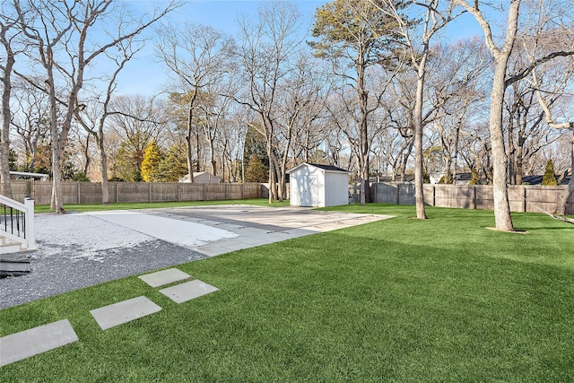 view of yard featuring a storage shed and a patio