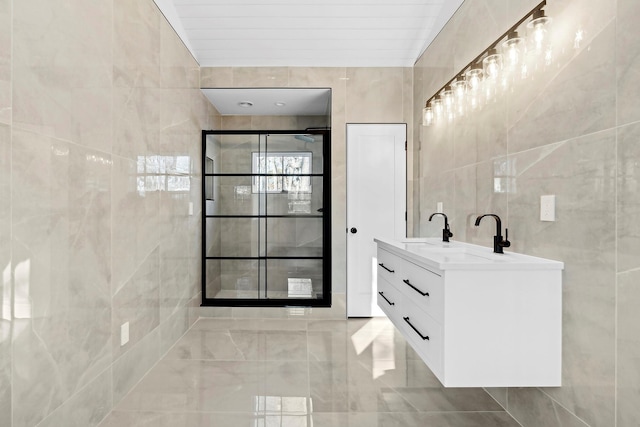 bathroom featuring vanity and tile walls