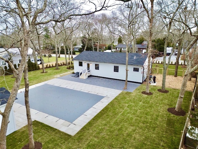 rear view of house with a patio area and a lawn