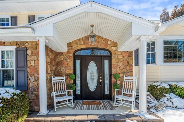 view of snow covered property entrance