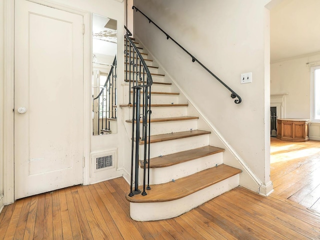 stairs featuring hardwood / wood-style flooring