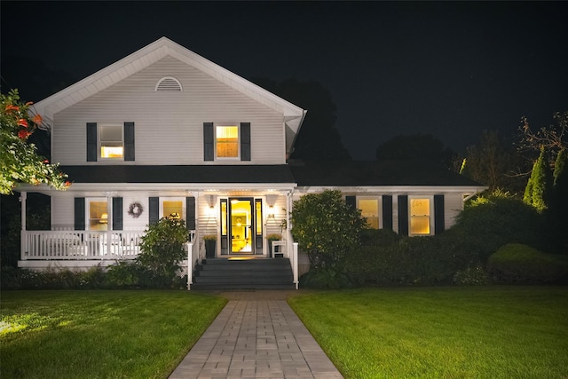 view of front of home with a porch and a yard