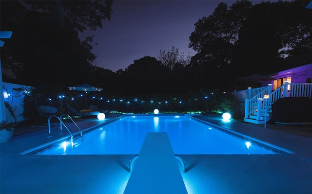 view of pool at twilight