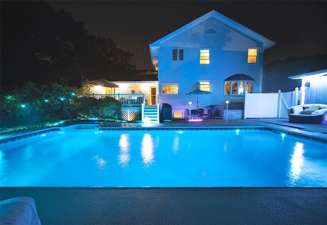 pool at night with a deck