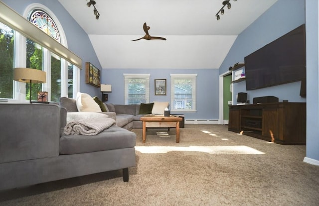 carpeted living room with vaulted ceiling, baseboard heating, plenty of natural light, and ceiling fan