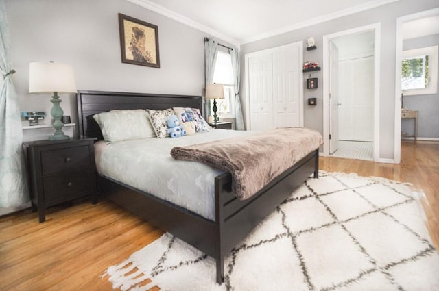 bedroom featuring a closet, ornamental molding, and hardwood / wood-style floors