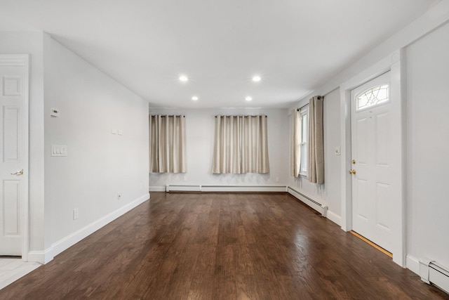 foyer entrance with hardwood / wood-style floors and a baseboard radiator