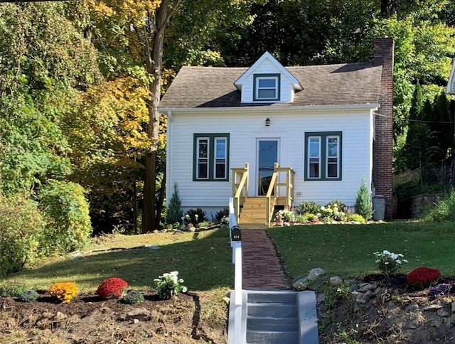 new england style home with a front yard