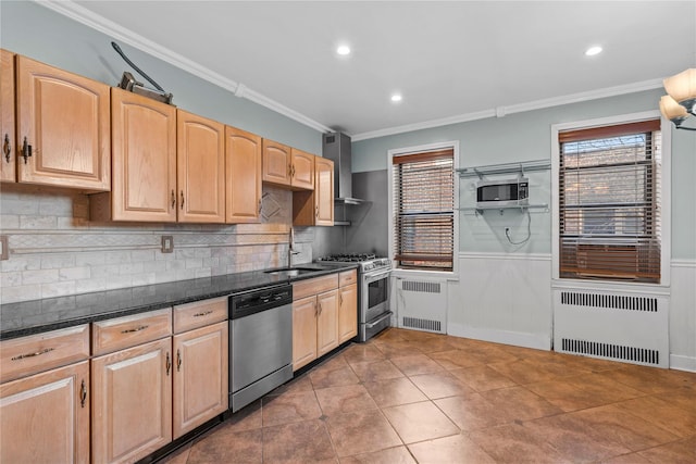 kitchen featuring appliances with stainless steel finishes, radiator, wall chimney exhaust hood, and dark tile patterned floors