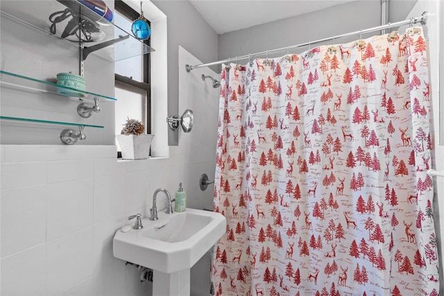 bathroom with sink, tile walls, tasteful backsplash, and curtained shower