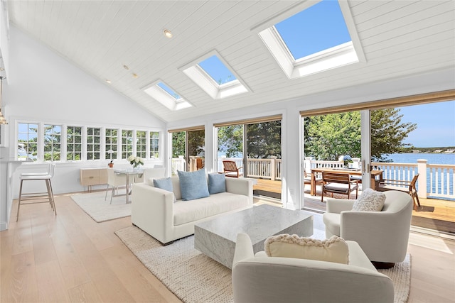 sunroom / solarium featuring a water view, lofted ceiling with skylight, plenty of natural light, and wooden ceiling