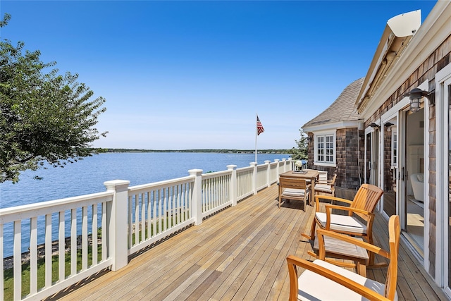 wooden deck featuring a water view