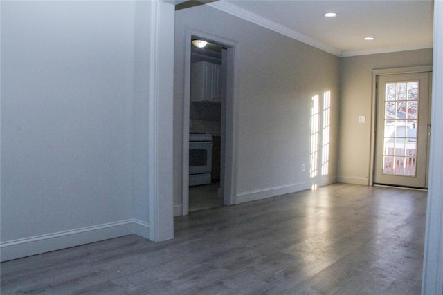 empty room featuring dark wood-type flooring and ornamental molding