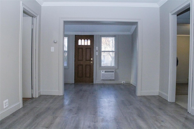 entryway featuring hardwood / wood-style floors, ornamental molding, and a wall mounted AC