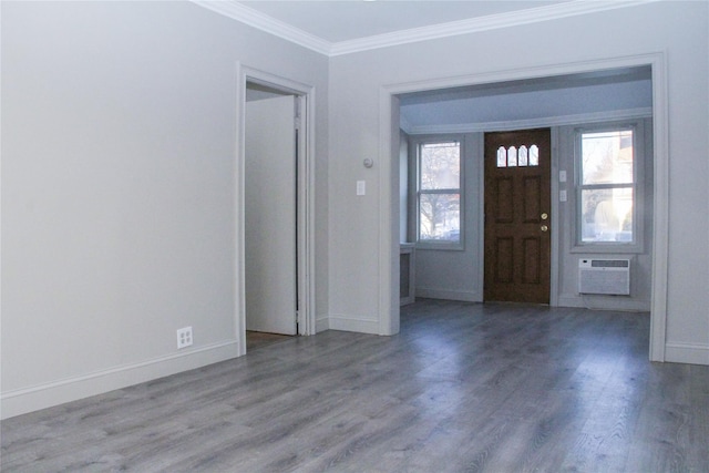 entryway with a wall mounted AC, ornamental molding, and hardwood / wood-style floors