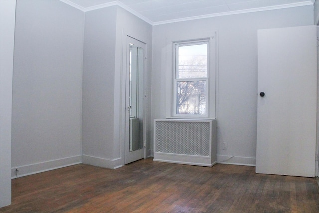 unfurnished room with radiator, ornamental molding, and dark hardwood / wood-style floors