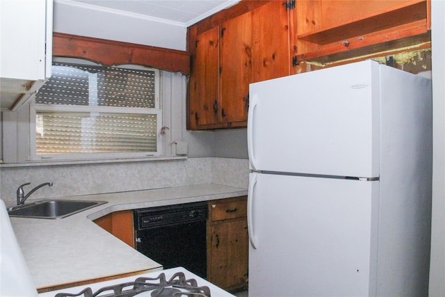 kitchen featuring white fridge, black dishwasher, tasteful backsplash, and sink