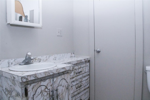 bathroom featuring toilet and vanity