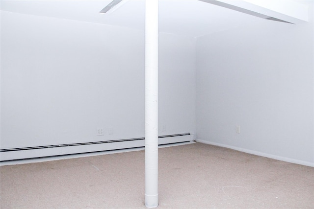 interior space with a baseboard heating unit and carpet flooring